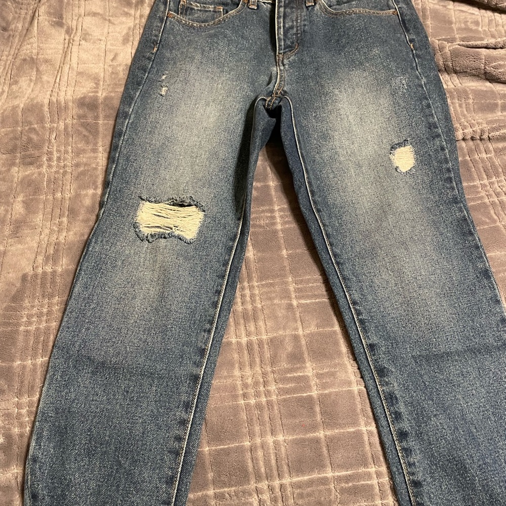 Boyfriend jeans with distressed look in lower pant legs